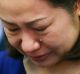 Choi Kyung-jin, the widow of South Korean businessman Jee Ick-joo, cries at the start of the Philippine Senate probe ...