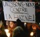 People attend a vigil in Montreal for victims of Sunday's shooting at a Quebec City mosque. Sign reads "let's unite ...