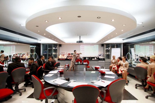 Prospective flight attendants for Emirates undergo training from an instructor, centre, in the image and uniform ...