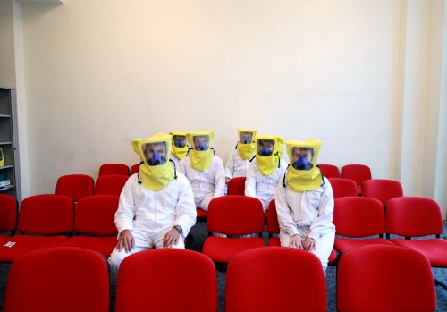Emirates trainee flight attendants sit in protective clothing during a training session.