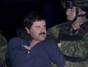 File - Joaquin "El Chapo" Guzman is made to face the press as he is escorted to a helicopter in handcuffs by Mexican soldiers and marines at a federal hangar in Mexico City, Mexico, Friday, Jan. 8, 2016.