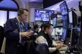 Trader Gregory Rowe, left, works with colleagues in their booth on the floor of the New York Stock Exchange, Monday, ...