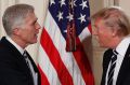 President Donald Trump shakes hands with Judge Neil Gorsuch on Tuesday.