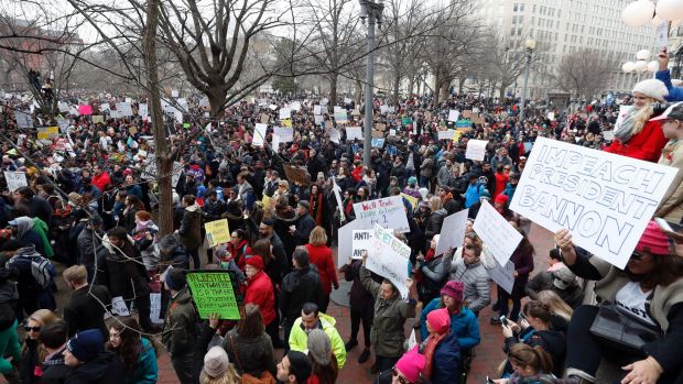 Protesters carry signs and chant in Lafayette Park near the White House during a demonstration to denounce President ...