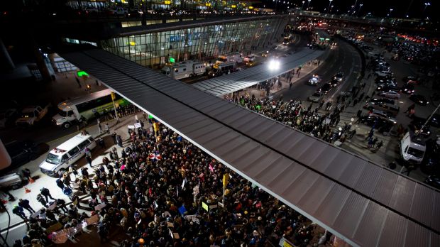 Demonstrators gather outside John F. Kennedy International Airport to protest against US President Donald Trump's ...