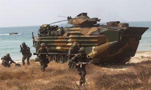 South Korean soldiers jump off an amphibious assault vehicle after hitting the ground during a military exercise, Cobra Gold, on Hat Yao beach in Chonburi province, Thailand Friday, Feb. 14, 2014.