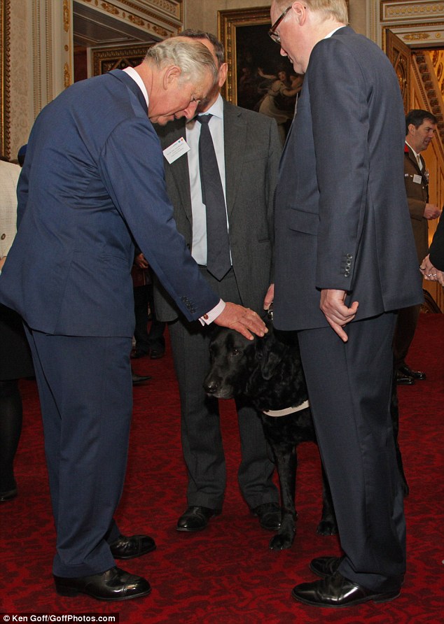 Prince Charles, an avid fan of dogs, petted a black Labrador at the event  