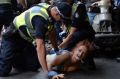 Police arrest a woman outside Flinders Street Station on Wednesday.