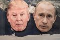 The masks of Donald Trump and the Russian President Vladimir Putin on a world map.