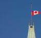 The flag flies at half-mast on the Peace tower in Ottawa. 