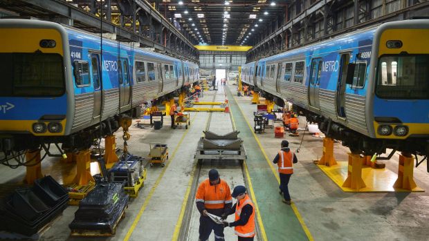 Downer EDI workers work on building new rail carriages.