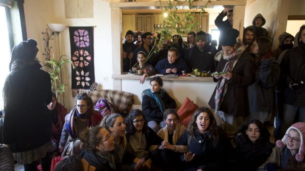 Israeli settlers, including children, barricade themselves in a house as Israeli security forces arrive.