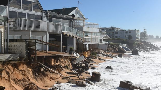 High tide begins to impact on damaged beachfront homes along Pittwater Road at Collaroy on the northern beaches of Sydney.