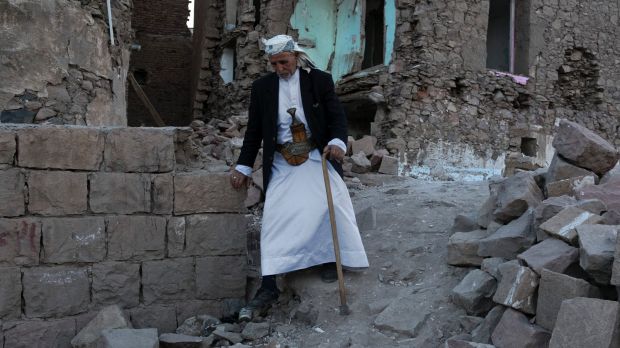 An elderly man passes destroyed homes in the old city of Sanaa in Yemen, the result of bombardment by a Saudi ...