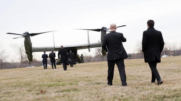 Legislators and officials board a V-22 Osprey at Fort McNair, Washington,  to travel to Dover Air Force Base in Delaware ...