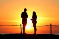A couple take in the sunrise at Cronulla Rock pool.
