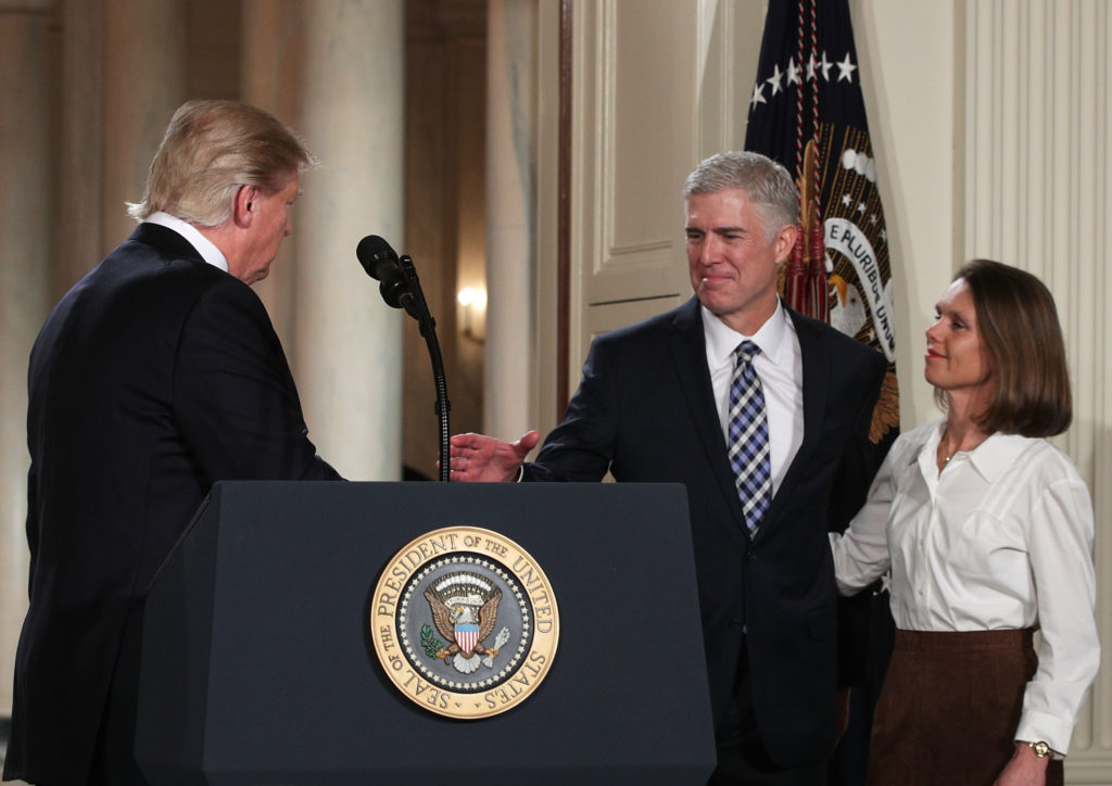 WASHINGTON, DC - JANUARY 31:  Judge Neil Gorsuch (2nd L) extends his hand for a hand shake as his wife Louise (R) looks on after U.S. President Donald Trump (L) nominated him to the Supreme Court during a ceremony in the East Room of the White House January 31, 2017 in Washington, DC. If confirmed, Gorsuch would fill the seat left vacant with the death of Associate Justice Antonin Scalia in February 2016.  (Photo by Alex Wong/Getty Images)