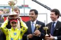 Sheikh Fahad Al Thani (centre) with French jockey Christophe Lemaire and trainer Mikel Delzangles after Dunaden won the ...