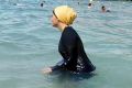 Nesrine Kenza enjoys swimming in her burkini in Marseille, France where dozens of local authorities banned its use, only ...