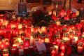 Visitors walk past a makeshift memorial at the reopened Breitscheidplatz Christmas market in Berlin after a truck killed ...