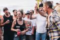 A group of men surround a young woman and shout 'black top, black top' requesting she remove her top. She didn't remove ...