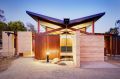 Recycled ironbark pergolas, with built-in bench-style seats, allow the indoors and outdoors to be blurred.