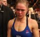 Bloodied and beaten: Ronda Rousey leaves the Octagon after her loss in December.