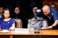 Philippines National Police Chief Ronald dela Rosa, right, shows Marissa Morquicho documents at the start of the probe. ...