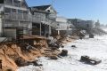 High tide begins to impact on damaged beachfront homes along Pittwater Road at Collaroy on the northern beaches of Sydney.