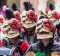 People in colorful fantasy costumes taking part in carnival Fastnachtsumzug.