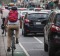 Cyclists navigate busy traffic.