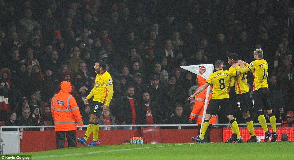 Deeney celebrates in front of the Arsenal supporters after handing his side a two-goal lead at the Emirates Stadium