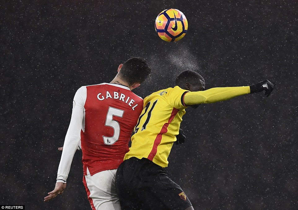 Gabriel leaps in the air to challenge Niang on a rainy night in north London in which Arsenal lost ground in the title race