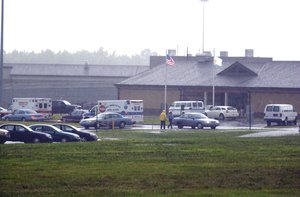 Ambulances and police are gathered at the Smyrna Delaware Correctional Center's main entrance where inmate Scott A. Miller was holding hostage a female employee in Smyrna, Del., Monday, July12, 2004.