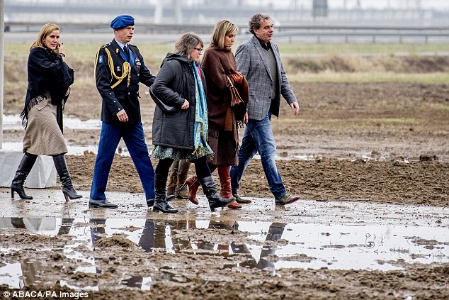 Queen Maxima was spotted picking her way through giant puddles at the wind farm yesterday