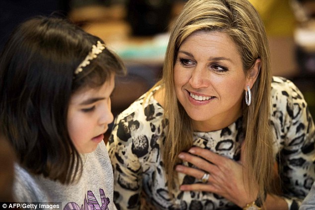 Queen Maxima of the Netherlands meets a young girl during her visit to the IMC Weekendschool in Haarlem in Amsterdam 
