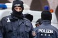 German police officers stand guard in front of a mosque during a terror raid in Frankfurt, Germany, on Wednesday.