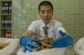 Shuquan Liu prepares ingredients at his Chinese Medicine Centre in Bondi Westfield.