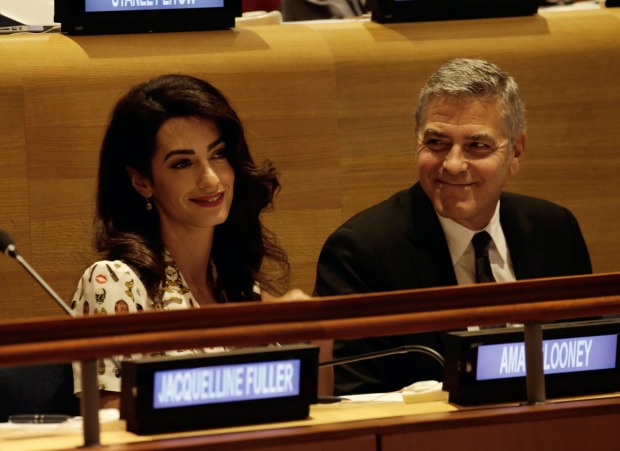 Actor George Clooney sits beside his wife, attorney Amal Clooney, at the UN: her celebrity may sometimes be a ...