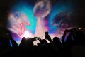 Colourful show: Football fans snap photos of the 3D light show projected on water at the Super Bowl Live event in Houston.