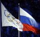 The Russian and Olympic flags fly at the tainted Sochi winter Olympics.