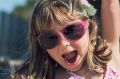 Little girl having fun at the beach in a sunny day Being playful, for Daily Life article?