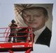 A policeman stands between portraits of Turkish President Recep Tayyip Erdogan, right, and the republic's founder, ...