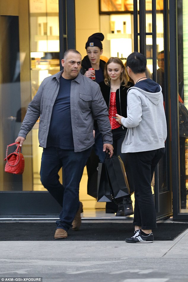 Casual style: The 17-year-old high fashion model put on a casual display as she left the designer boutique wearing a red and white polka-dot shirt and black pants