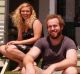 Ashleigh and Dan sit outside their tiny home.