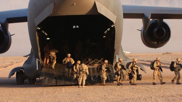 Members of the Australian Special Operations Task Group disembark a United States Air Force C-17 Globemaster at a base ...