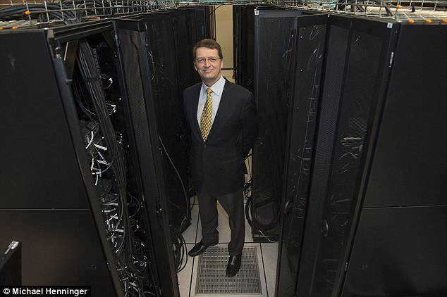 Carnegie Mellon computer science Professor Tuomas Sandholm standing with the Pittsburgh Supercomputing Center's Bridges Computer, which was used to develop Libratus' strategy before and throughout the event