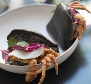 Clean Scandi/Jap vignette: Black bun with deep-fried softshell crab and bonito pastrami.
