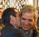 Ali Vayeghan, an Iranian citizen with a valid U.S. visa, third from left, kisses his brother Houssein Vayghan, with his ...