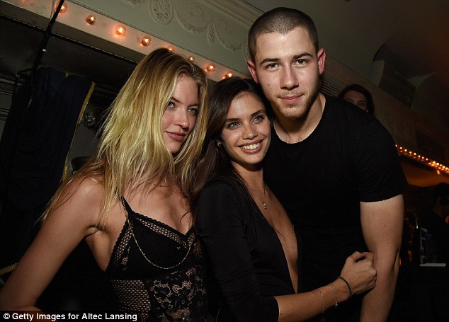 With a blonde pal: 'They had a lane to themselves and had their hands all over each other,' an eyewitness claimed. Here they are also seen in June and are joined by Martha Hunt (far left)